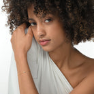 Frau trägt eine vergoldete Armkette mit einem einzelnen brillanten Labordiamanten im Marquiseschliff.